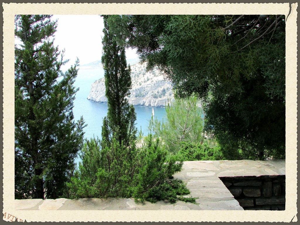 YACHT THROUGH THE TREES. ST MICHAELS MONASTERY. THASSOS ISLAND. GREECE.